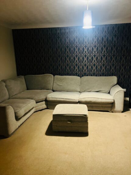 Corner sofa with footstool